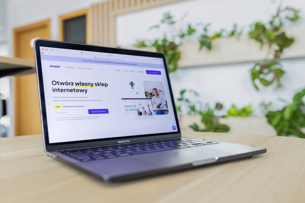 pexels-photo-16675632 Close-up of a laptop with an open e-commerce website, surrounded by modern office decor.