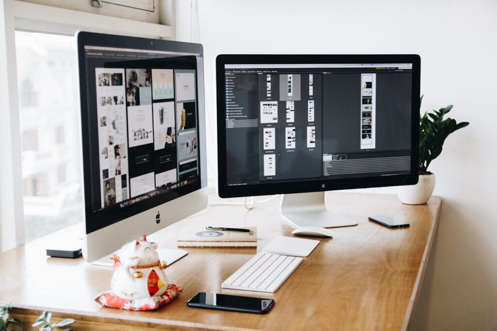 pexels-photo-326503 A well-organized design workspace with dual monitors and design software on display.